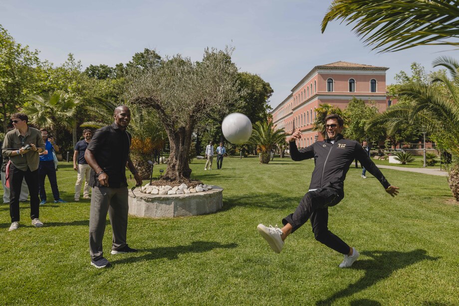 E1 Series: Tom Brady and Didier Drogba play football